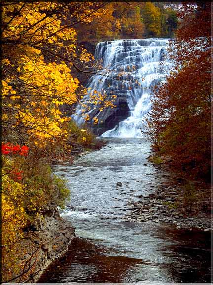 Autumn reds and golds suround Ithaca Falls in Ithaca, NY.